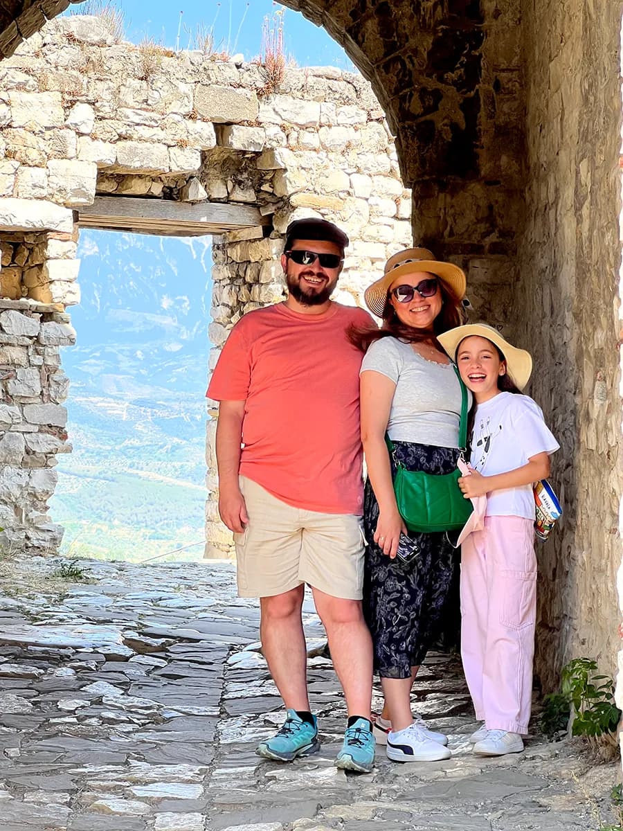 Can Egridere with his family outdoors in a historic stone setting, reflecting life beyond code, design, and creative development